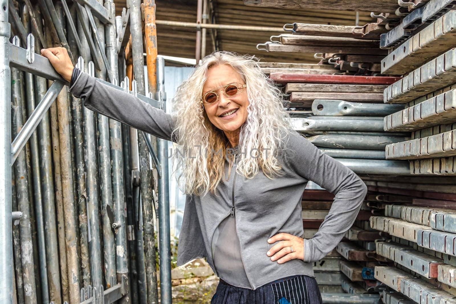 Stylish Lady with long curly hair surround industry area.