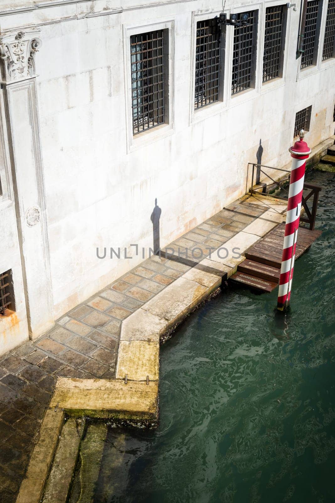 Metallic Poles By Jetty At Canal In City of venice