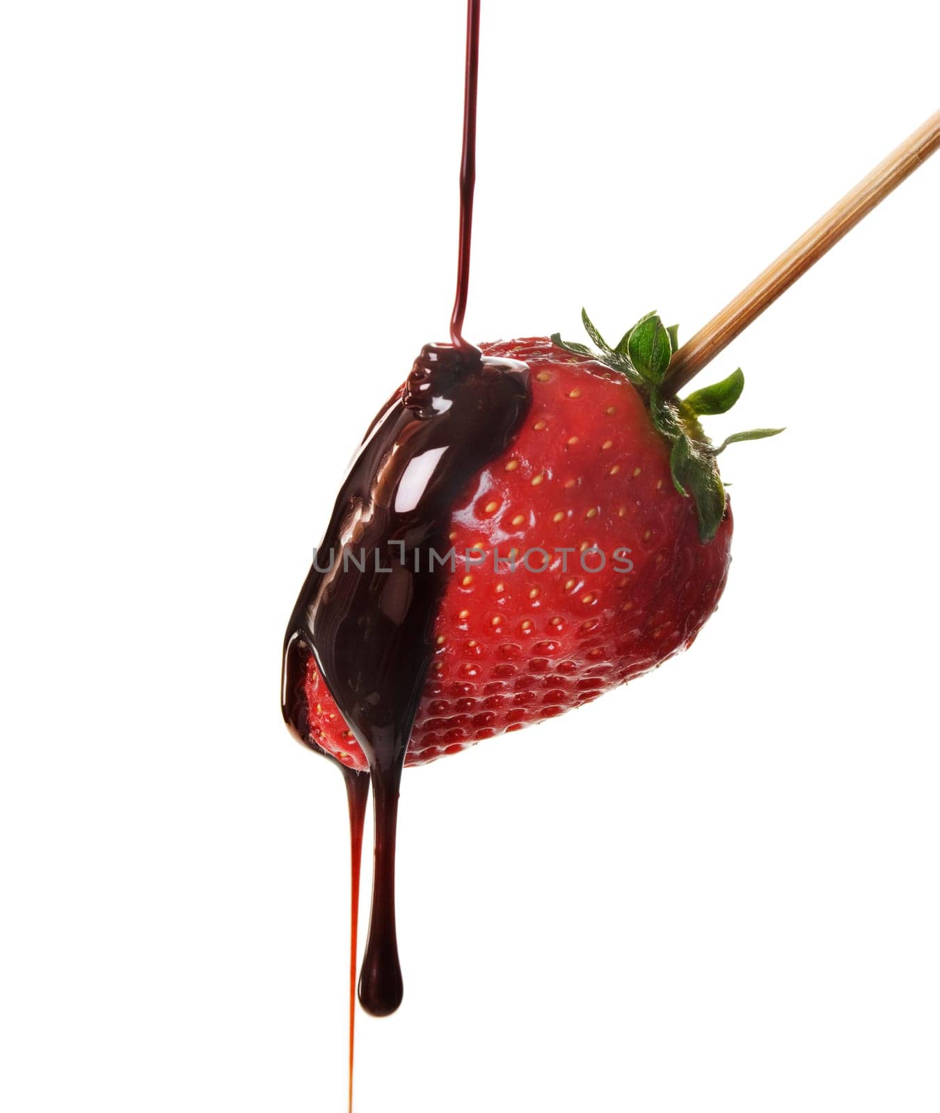 Pouring chocolate over fresh yummy strawberry