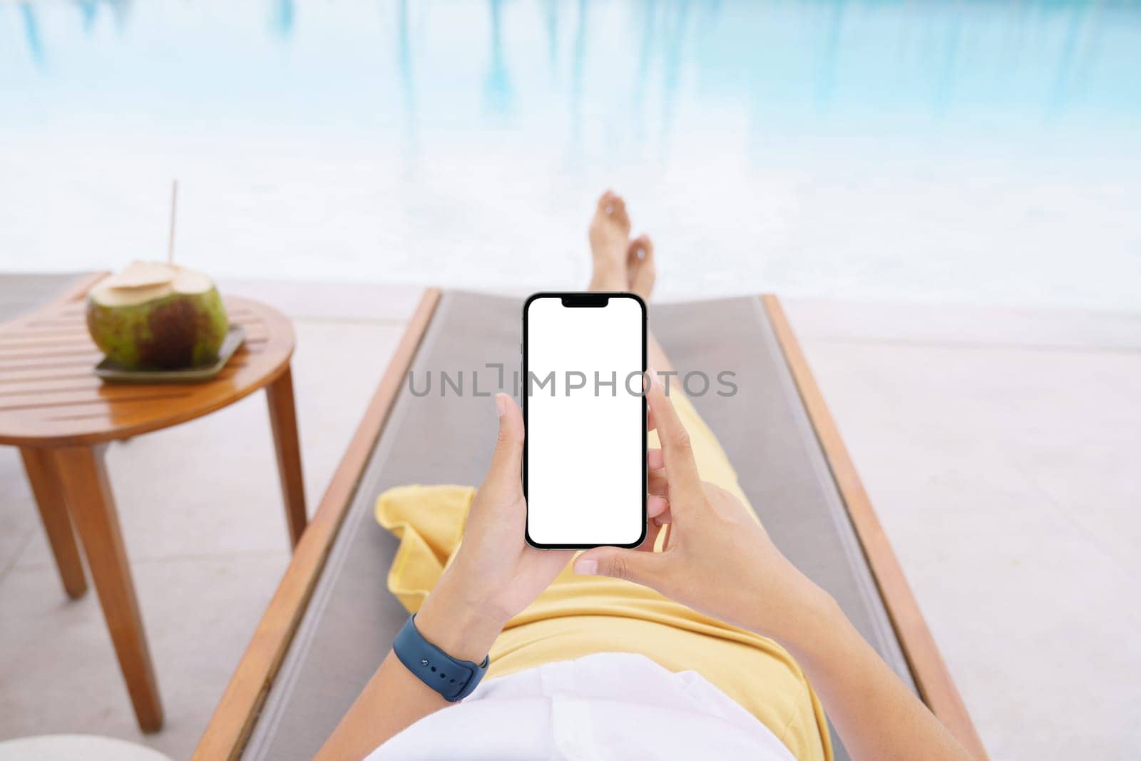 woman lie down on pool bed using phone white screen
