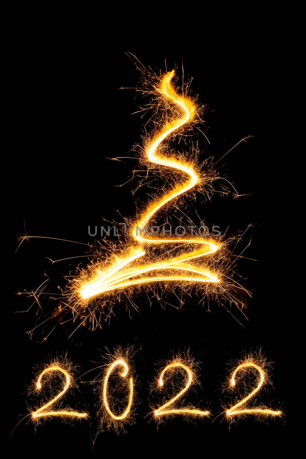 Merry christmas and happy new year 2022. Sparkling firework christmas and new year text on black background. Minimal abstract artistic style.