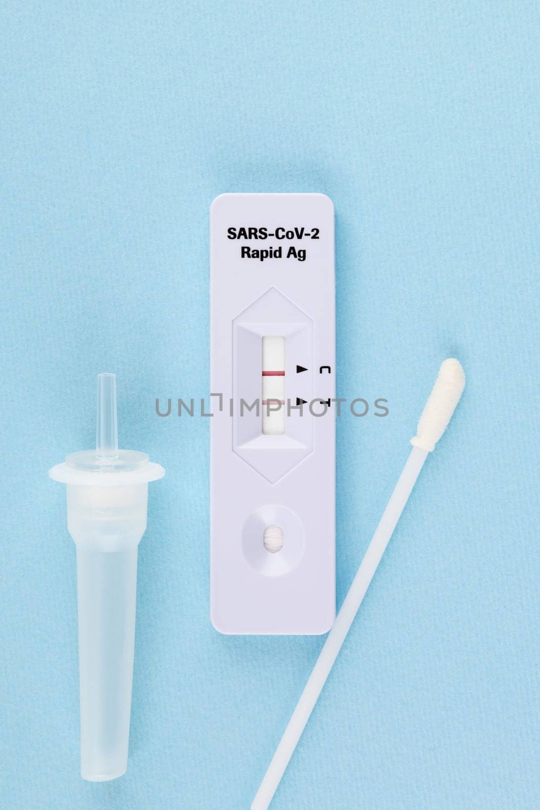 Positive covid 19 test on blue backround. Corona nasal swab test.