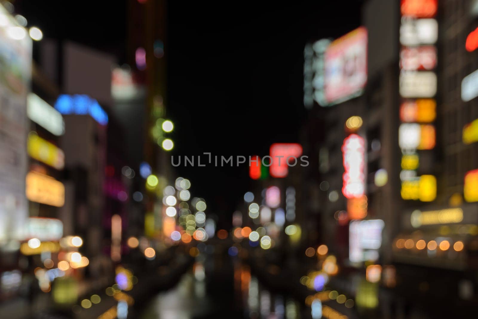 Abstract blur Illuminated billboards of store and restaurant at night in Osaka, Japan