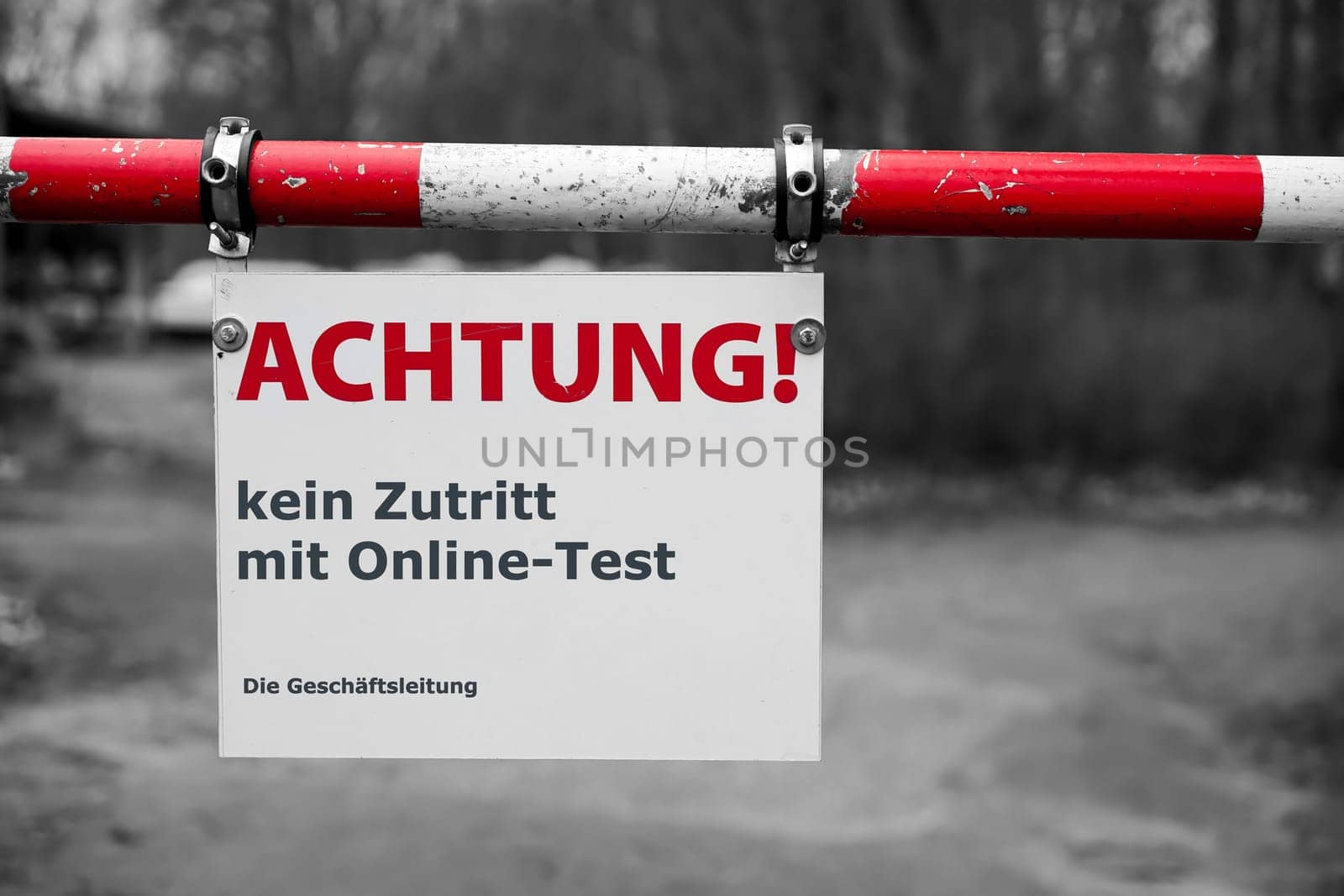Restricted access at the barrier to a company site in germany during the Corona Pandemic. Translation: Attention, no access with online Corona Test. The Management.