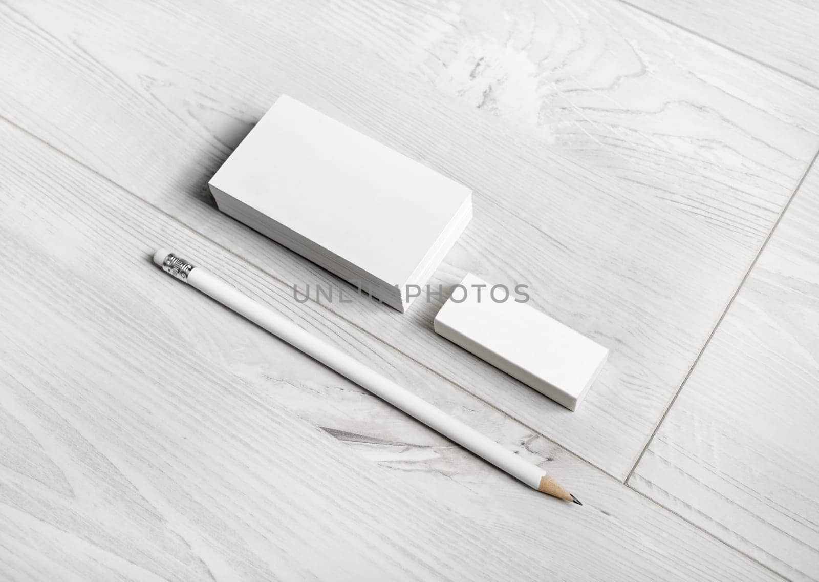 Blank business cards, pencil and eraser on wood background. Template for ID.