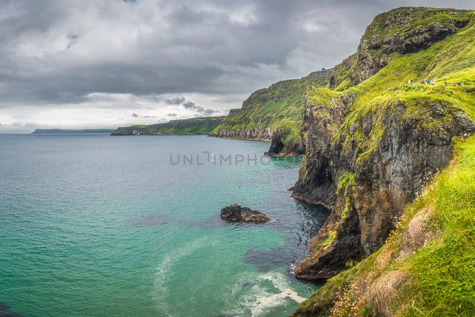 Coastline with tall limestone cliffs, Rathlin Island and turquoise Atlantic Ocean near Carrick a Rede rope bridge, Wild Atlantic Way, Northern Ireland