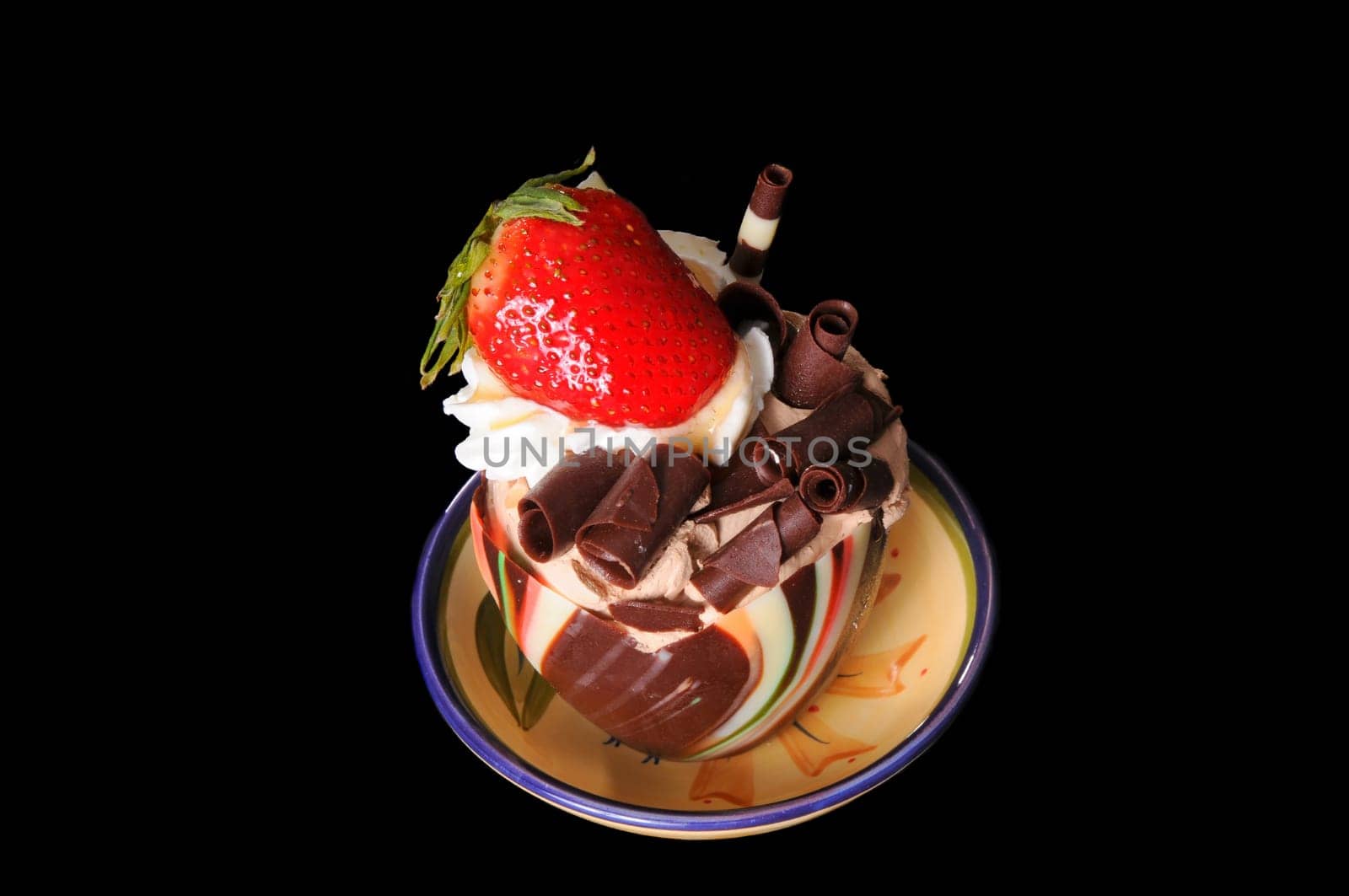 Frozen parfait ice cream and chocolate delight with strawberry isolated over black