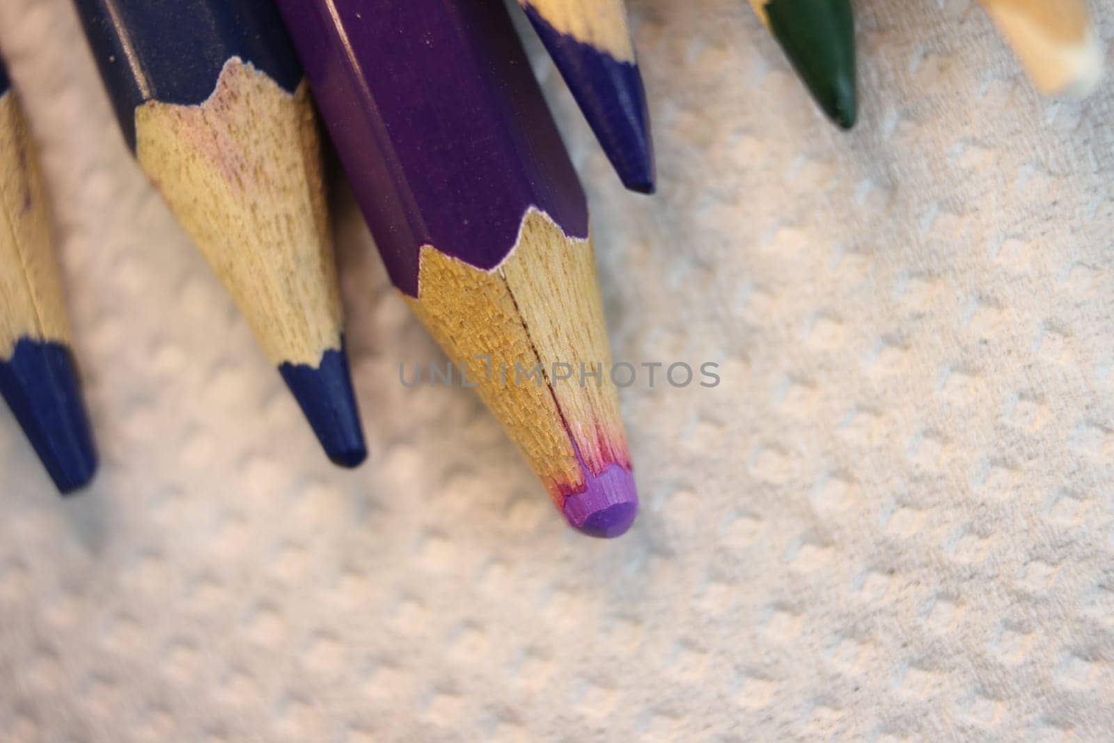 Close-up view of bright colored multicolor pencils on black background
