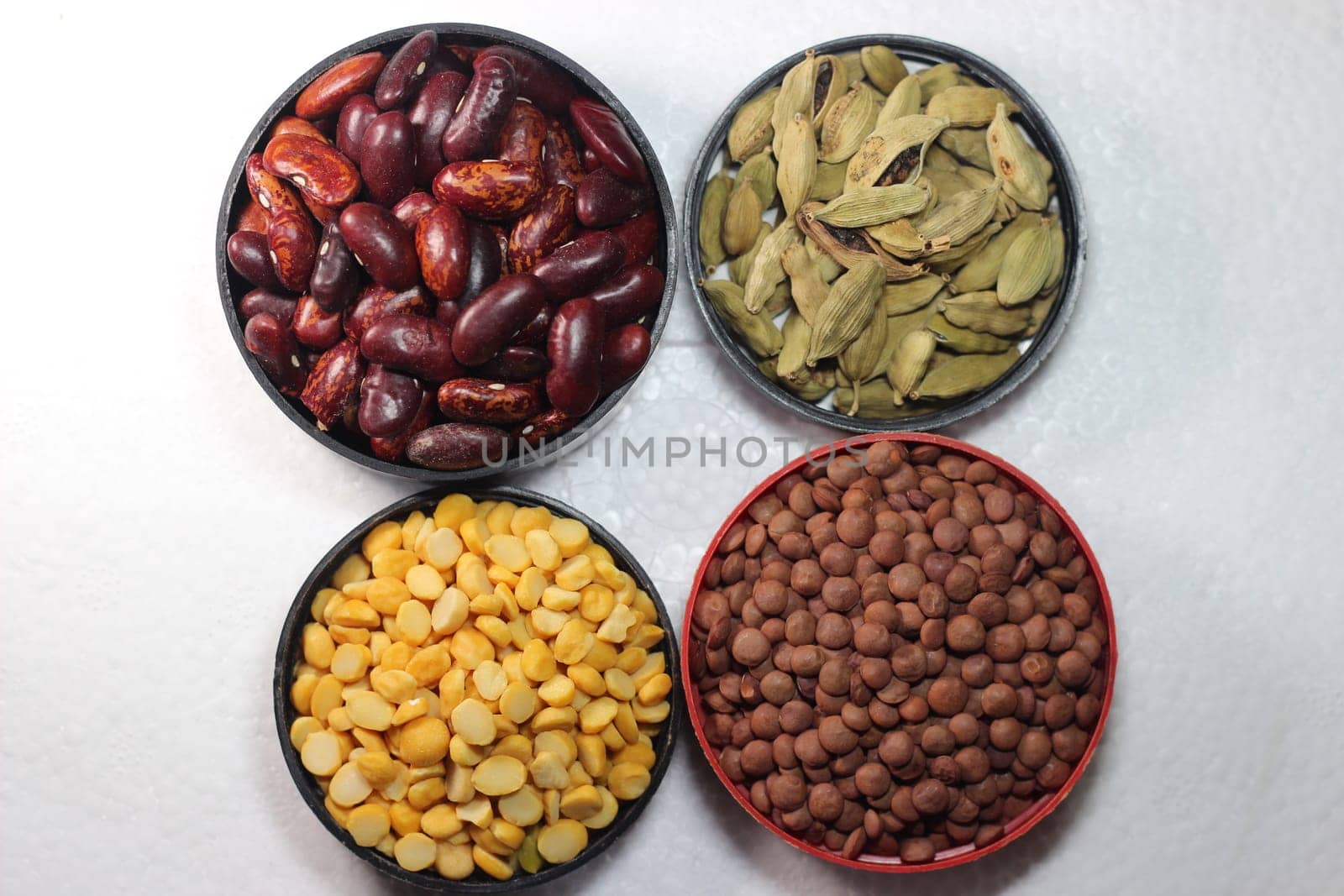 Top view of assortment of cereals, and cardamom. Collection of different spices and cereals.