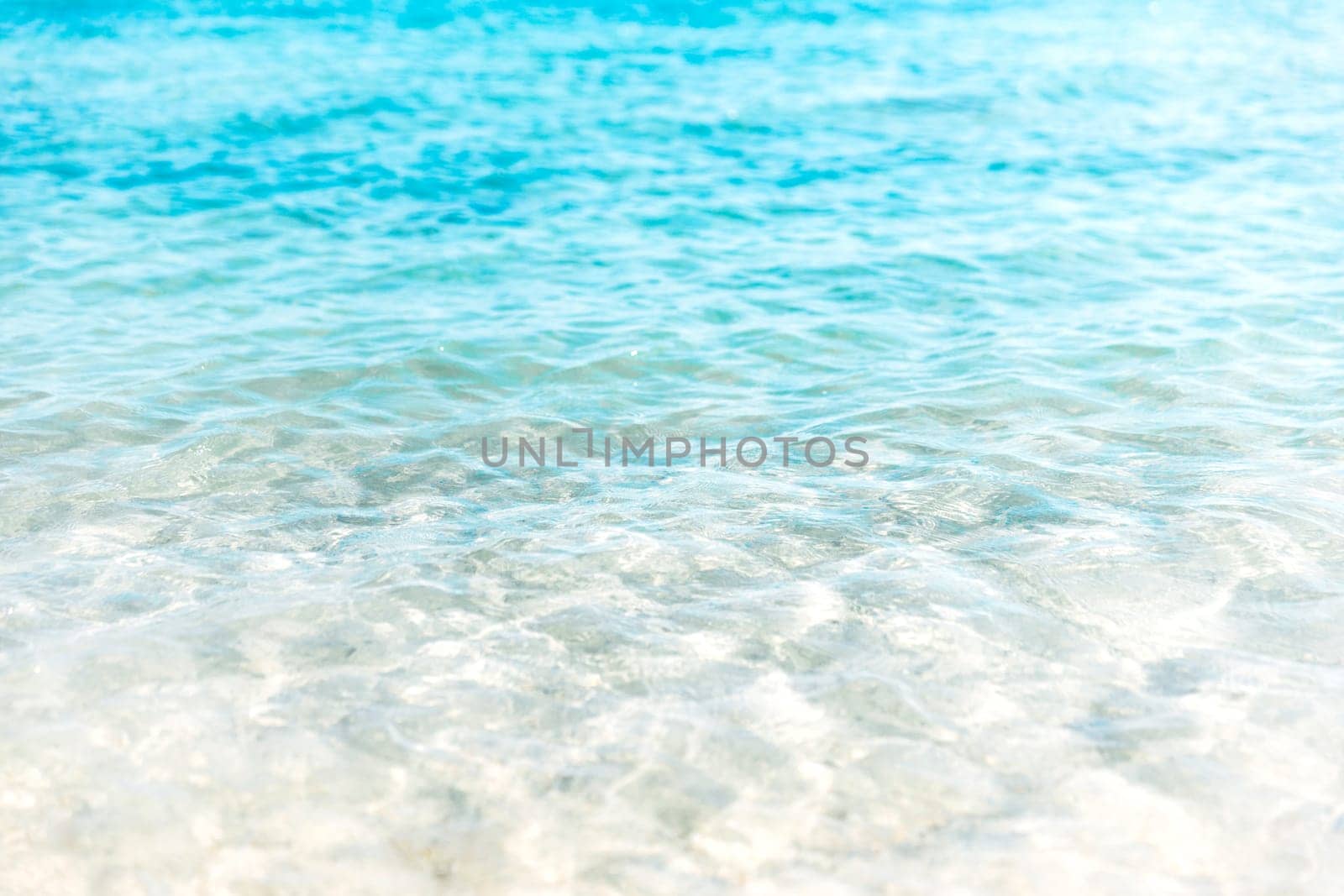 Close up aerial view of crystal clear turquoise sea and soft blue ocean waves, white foam on golden sandy tropical island summer beach, holidays border frame concept background, copy space