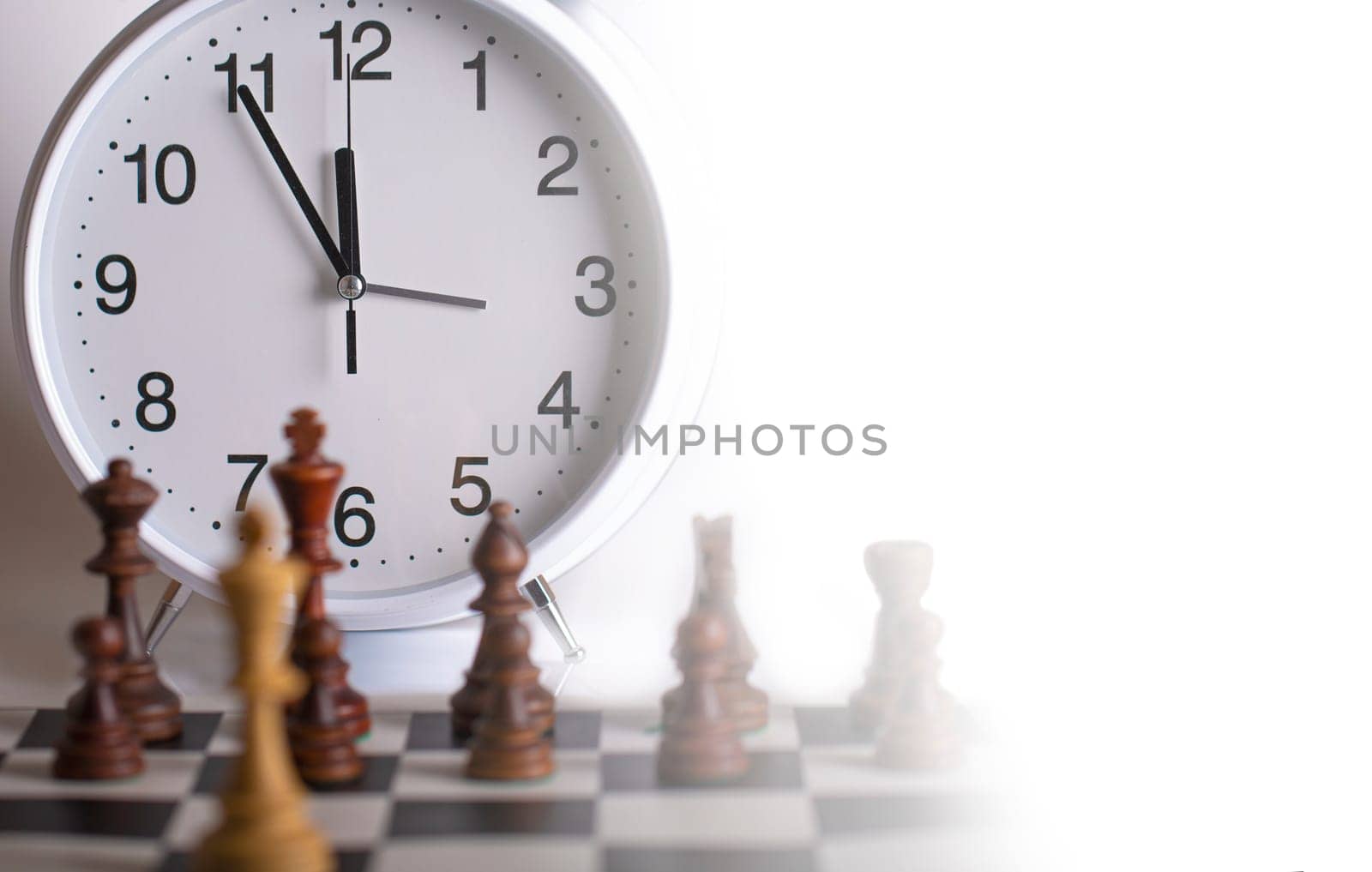 The Clock and Chess pieces on a chessboard. as background. The concept of playing and winning a chess tournament