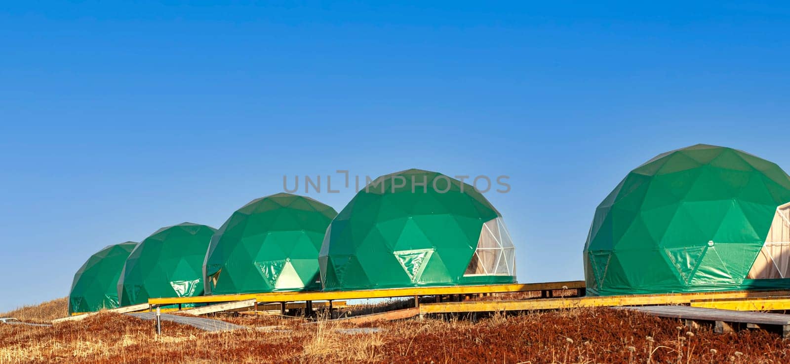 The Green geo-dome tent on Kamchatka peninsula. Cozy, camping, glamping, holiday, vacation lifestyle concept. Outdoors cabin, scenic background