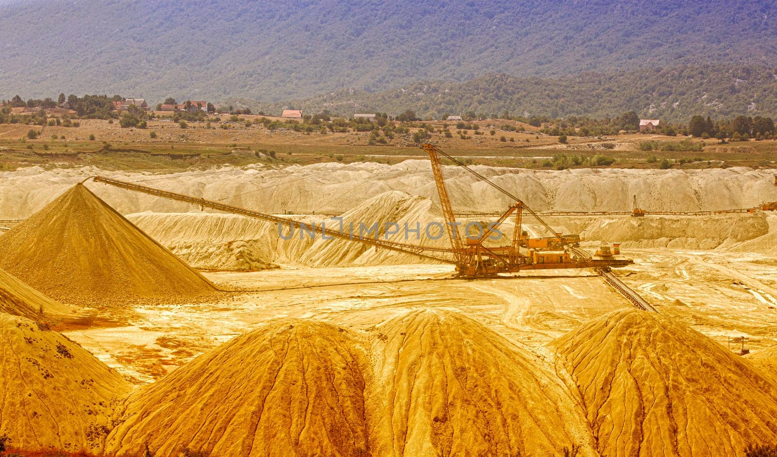 The own coal open pit landscape with enormous digging excavator