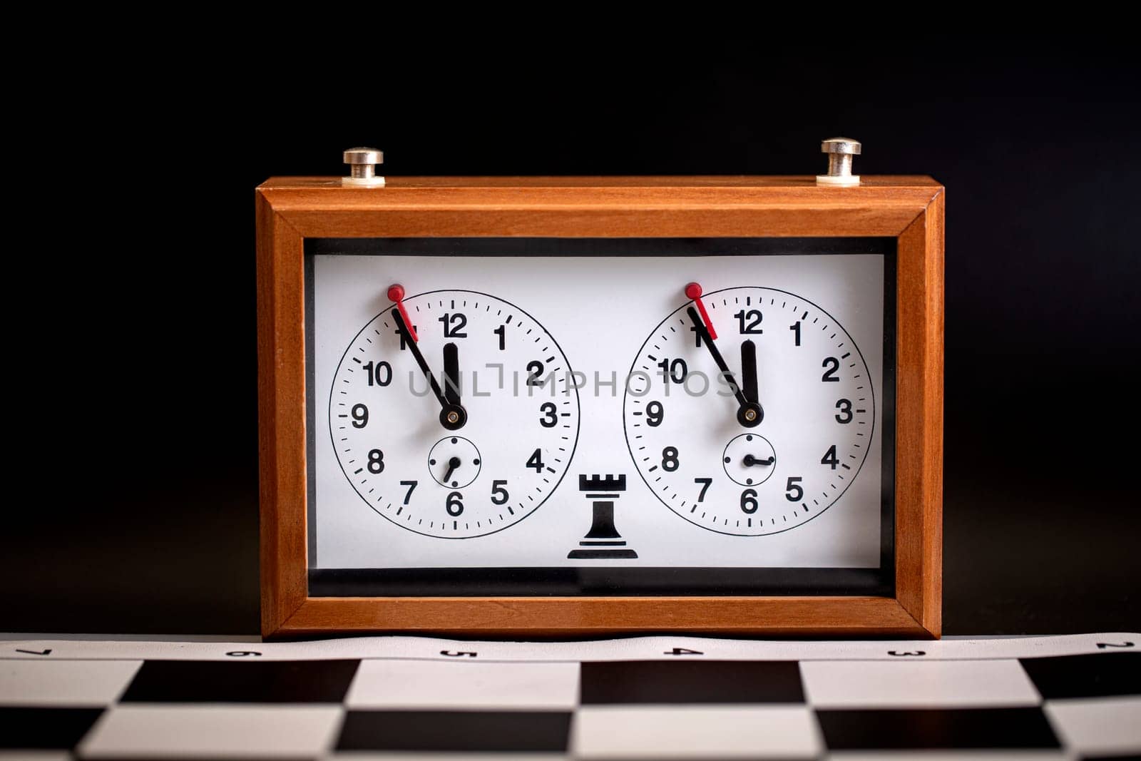The  classic, mechanical chess clock on wooden chess board. Selective focus
