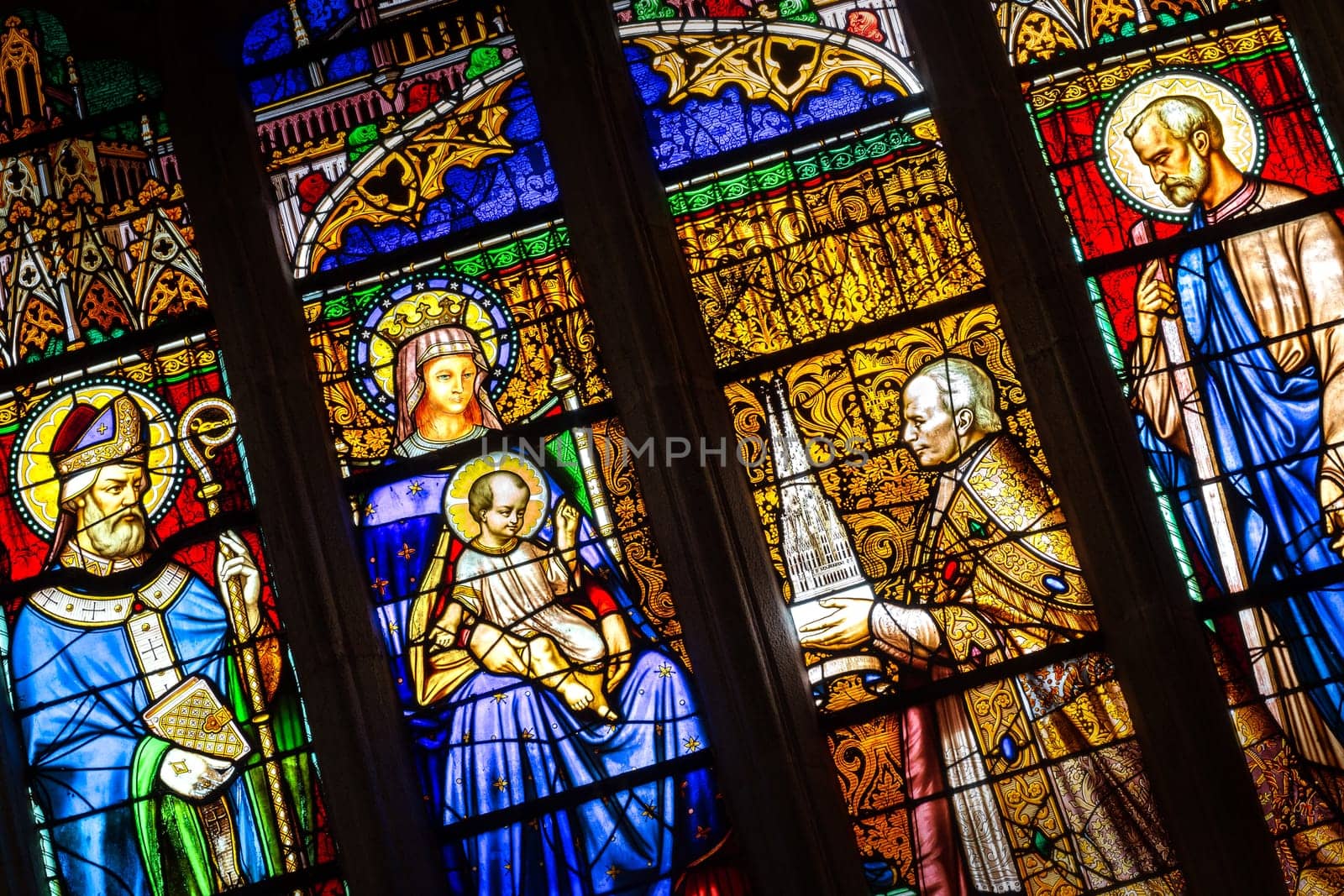 Quimper, Brittany, France - August 11 2017 : Stained glass in the Cathedral of Saint Corentin. Bishop his grace Graveran offering cathedral to Our Lady and St Corentin.