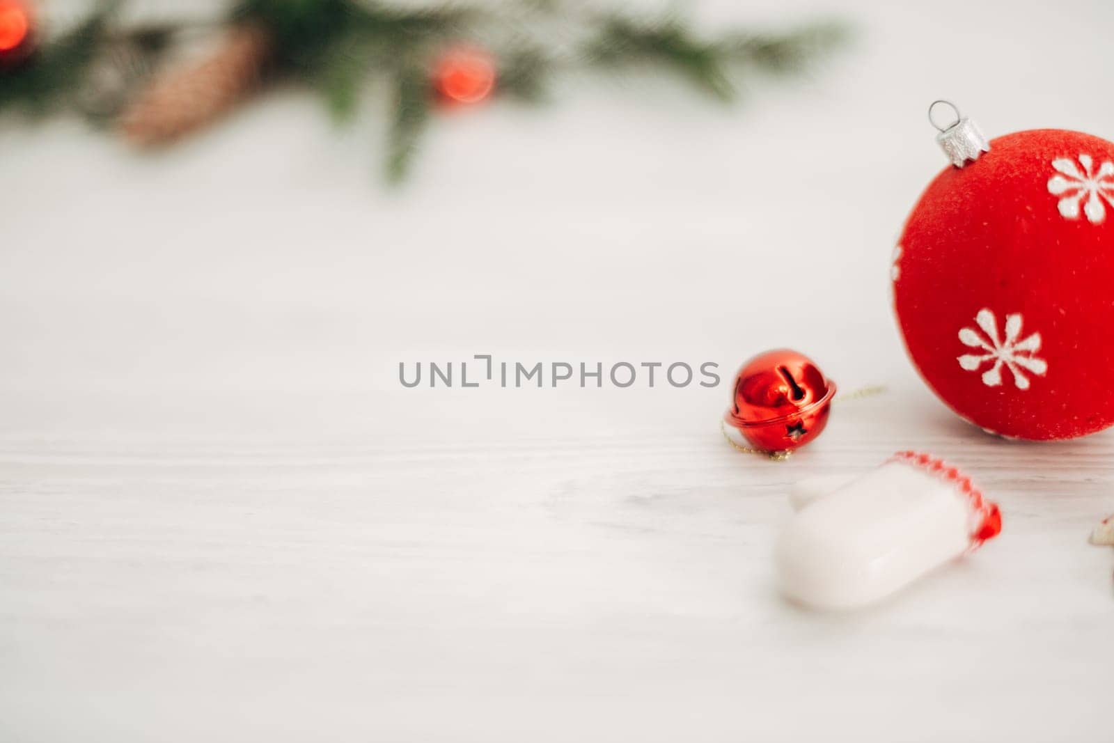 Christmas Red Decorations on a White Wooden Table with Copy Space Text