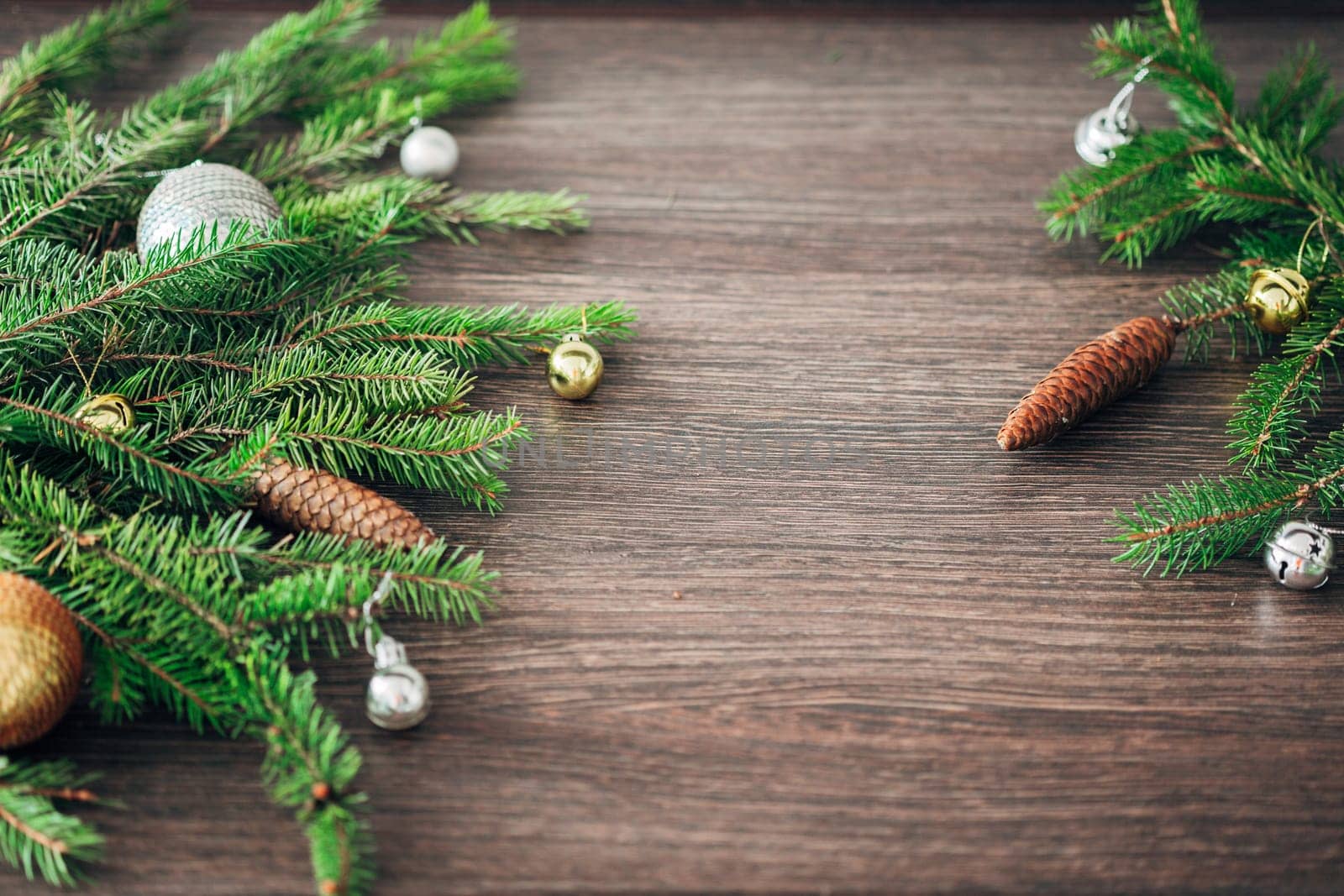 Decoration of Christmas Tree Green Branches on a Brown Background with CopySpace