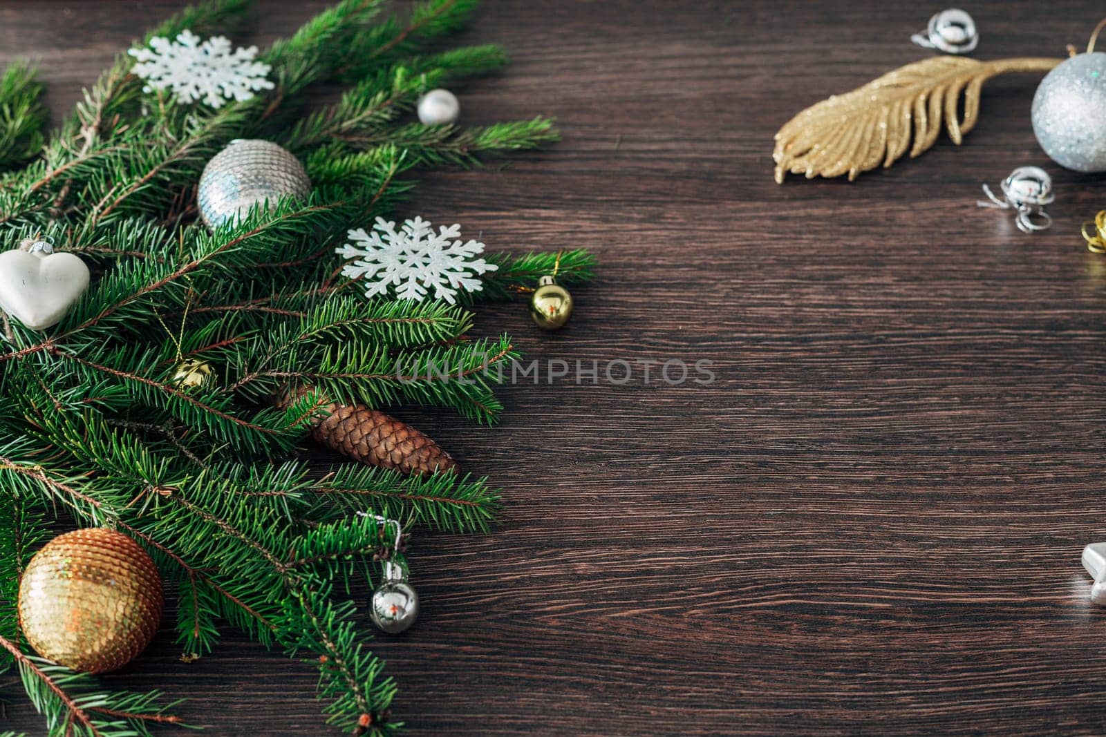 Decoration of Christmas Tree Green Branches on a Brown Background with Copy Space