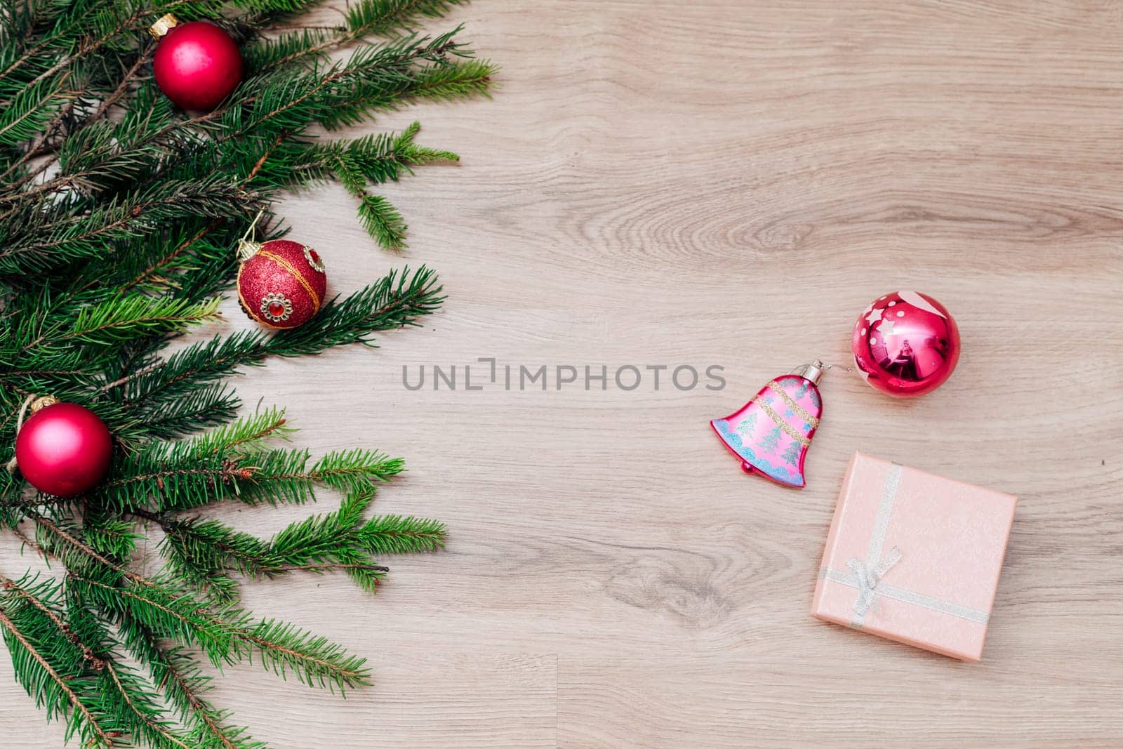 Decoration of Christmas Tree Green Branches on a Wooden Background with Copy Space