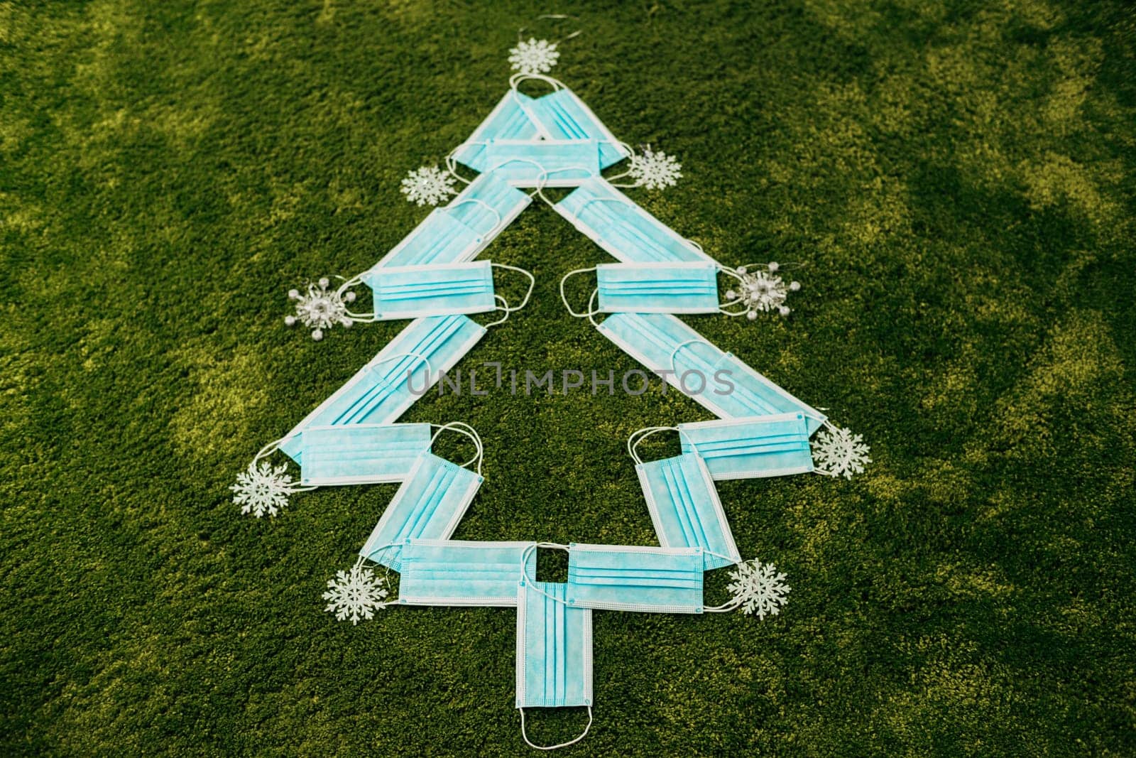 Medical Blue Masks Made Christmas Tree on a Green Background