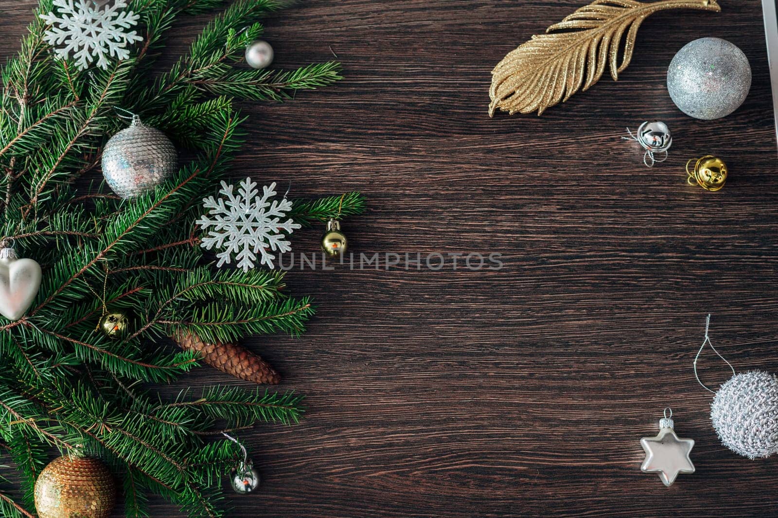 Decoration of Christmas Tree Green Branches on a Brown Background with Copy Space