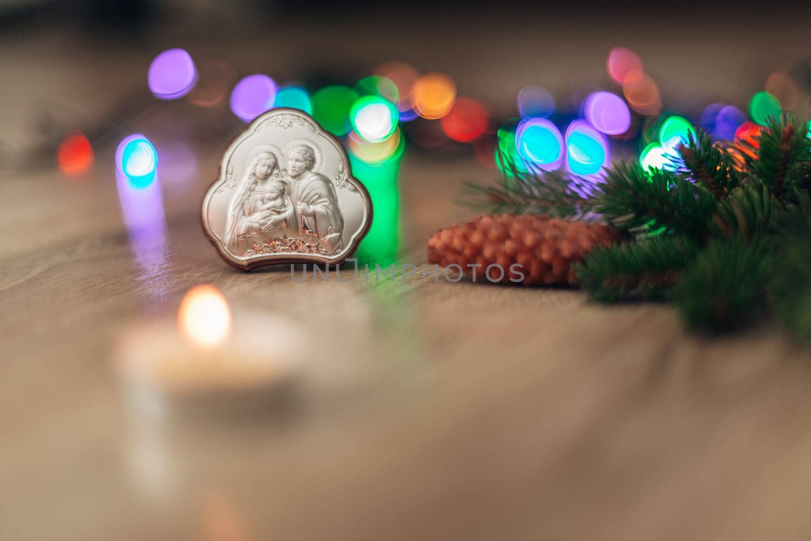 Christmas Composition of Church Icon on a Wooden Background With Multicolored Light Boken