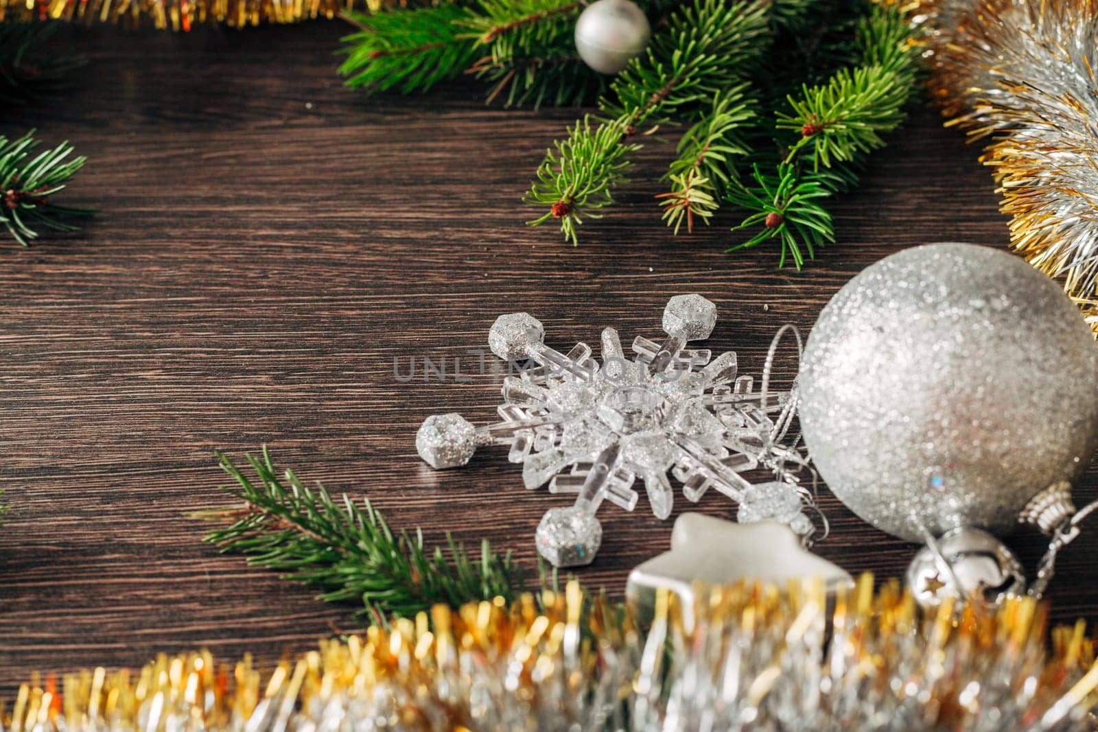 Decoration of Christmas Tree Green Branches on a Brown Background with Copy Space
