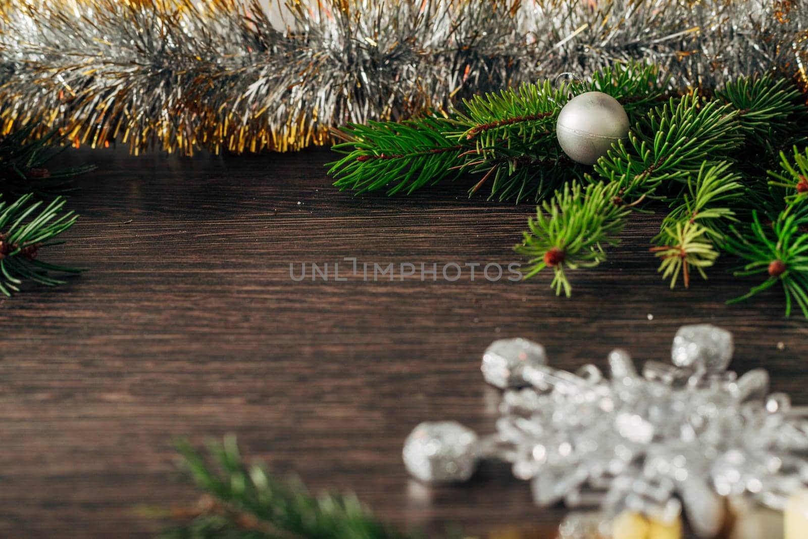 Decoration of Christmas Tree Green Branches on a Brown Background with Copy Space
