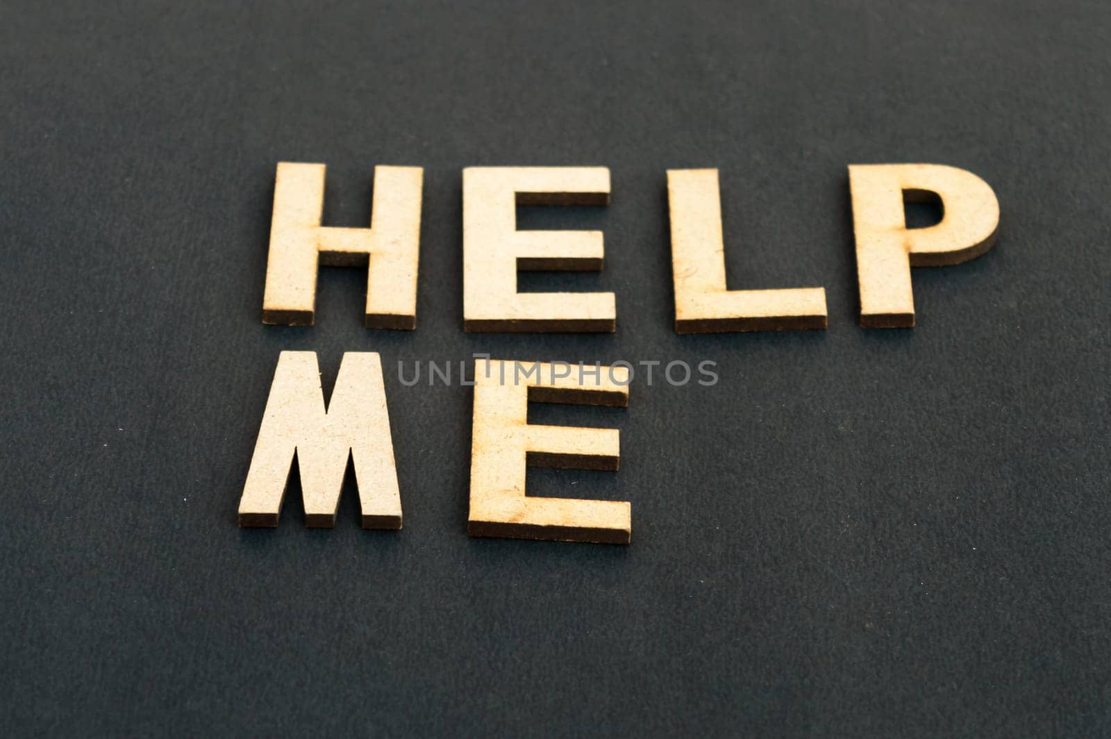 Help me symbol. Wooden cubes words help me isolated on black background, copy space. Business, motivational and help me concept.