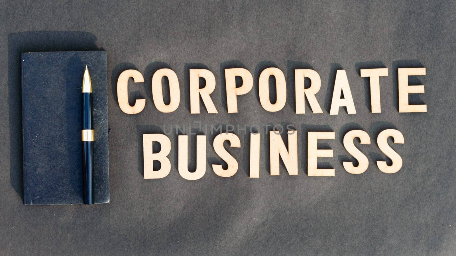 Corporate word and business concept. Wooden cubes words Corporate Business isolated on black background. Business Finance Industry concept.
