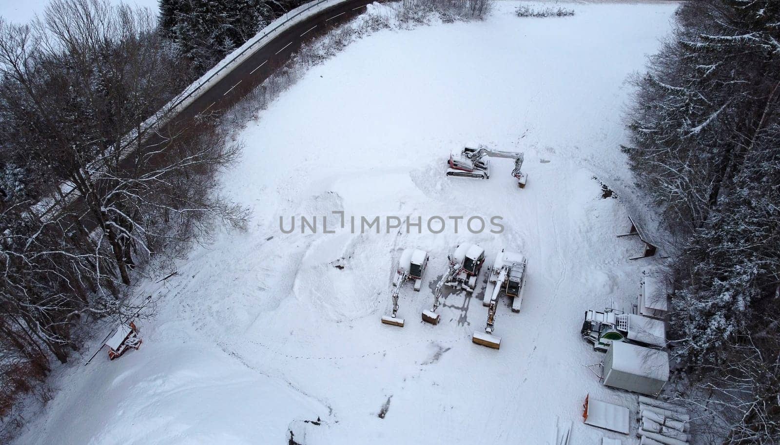 Aerial view with a drone of a road and excavator in winter
