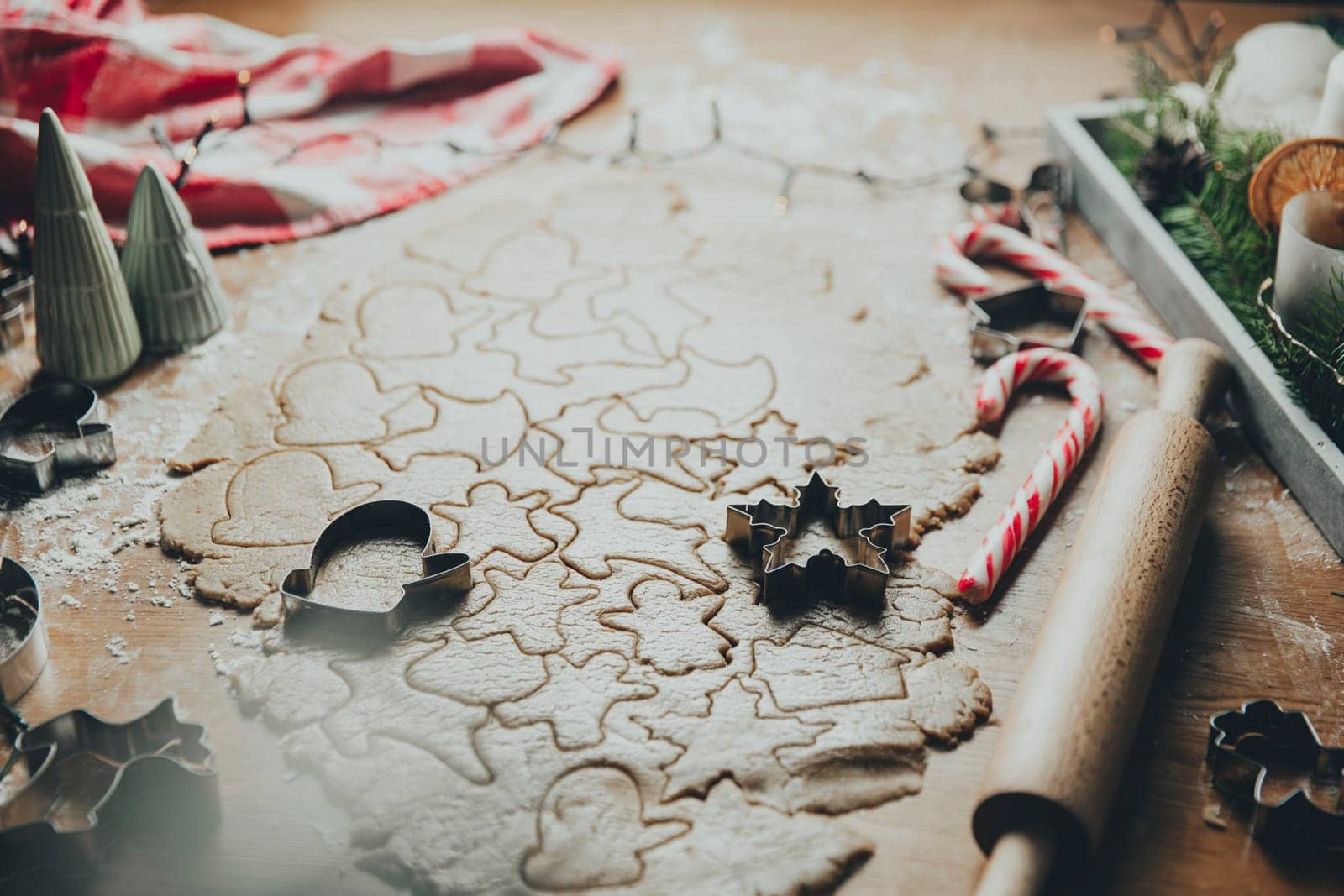 Merry Christmas, Happy New Year. Gingerbread cookies cooking, rolled dough on the table, different cutting forms, star, heart, animals. Festive family cook, bake sweets for kids. High quality photo