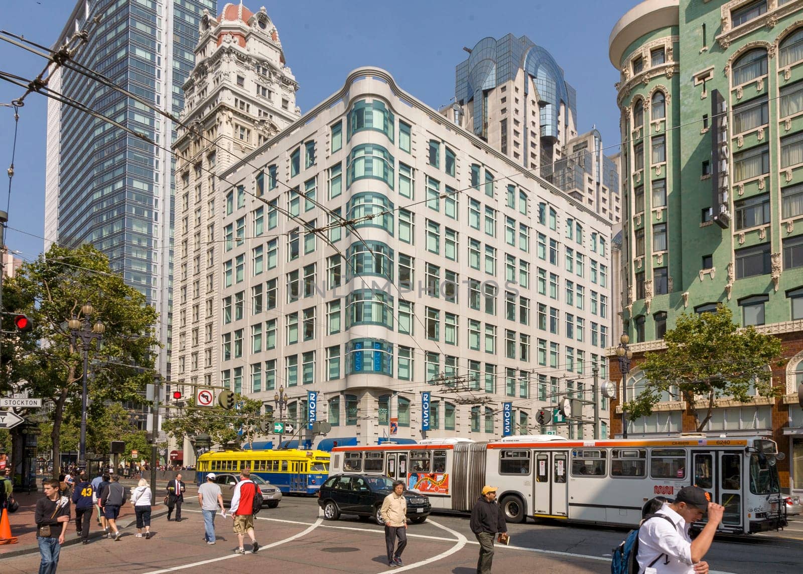 San Francisco, USA - July 25, 2008:   people downtown in San Francisco are shopping on a summer day. The overhead bus and streetcar passing the main road.