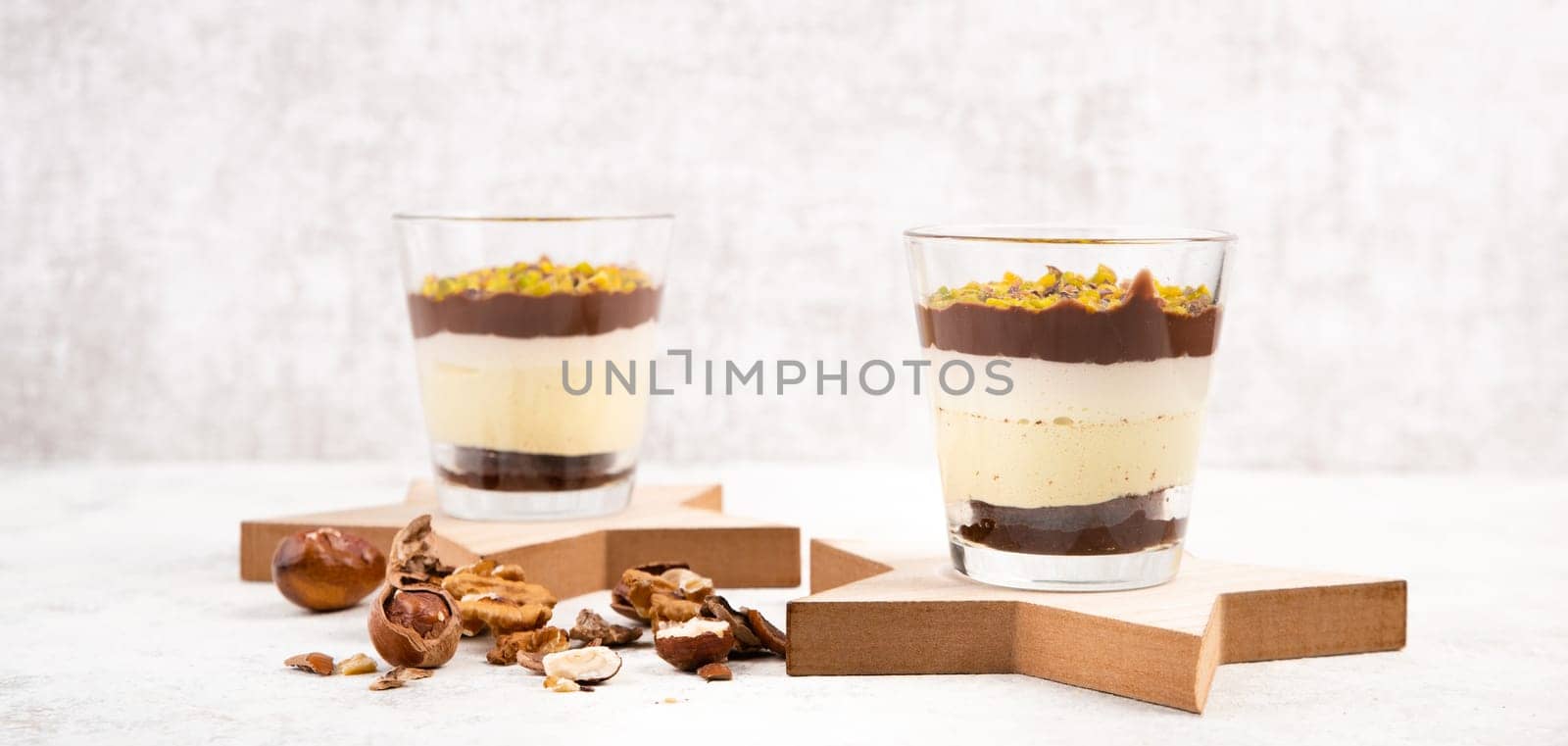 Dessert with chocolate cream, cake and nuts in a glass, sweet food, christmas season