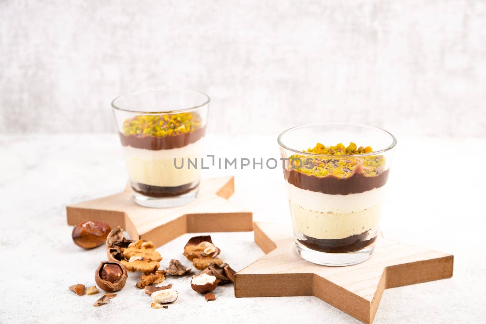 Dessert with chocolate cream, cake and nuts in a glass, sweet food, christmas season