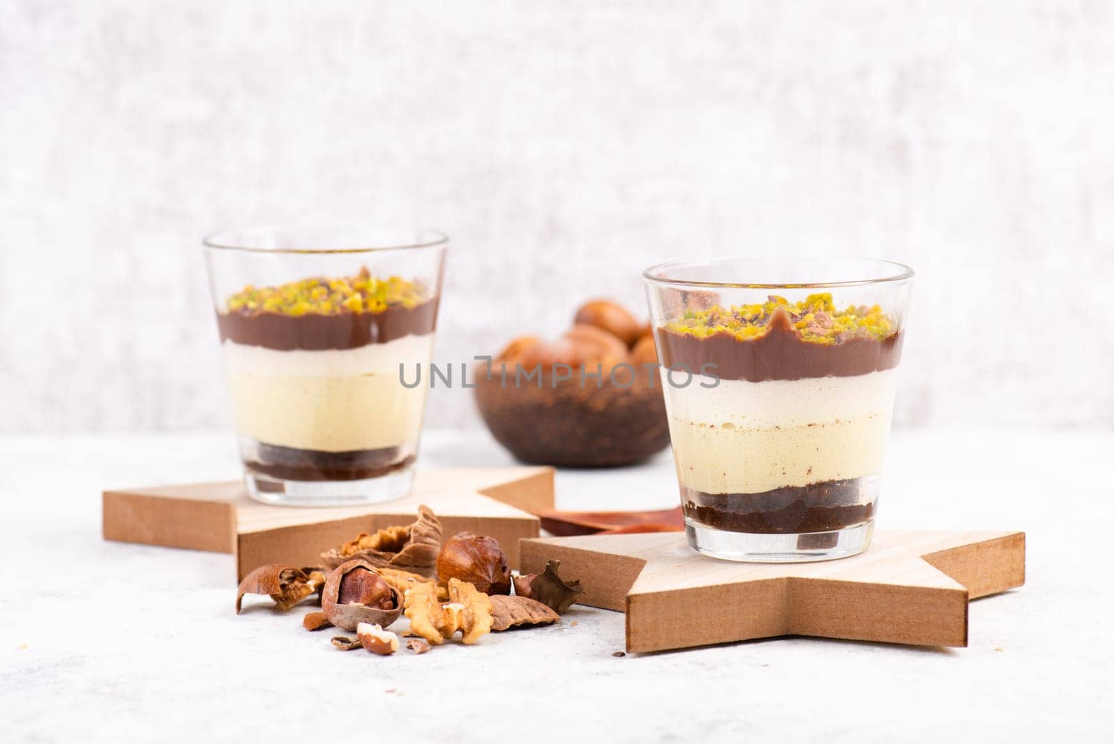 Dessert with chocolate cream, cake and nuts in a glass, sweet food, christmas season