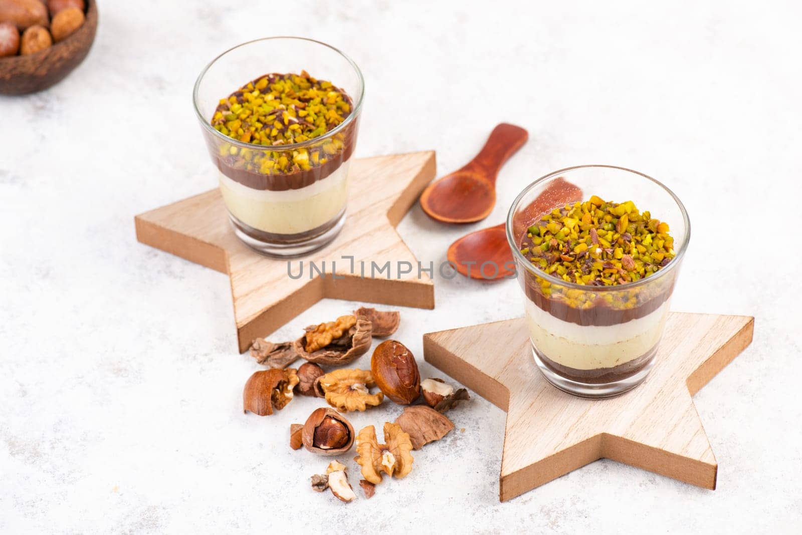Dessert with chocolate cream, cake and nuts in a glass, sweet food, christmas season