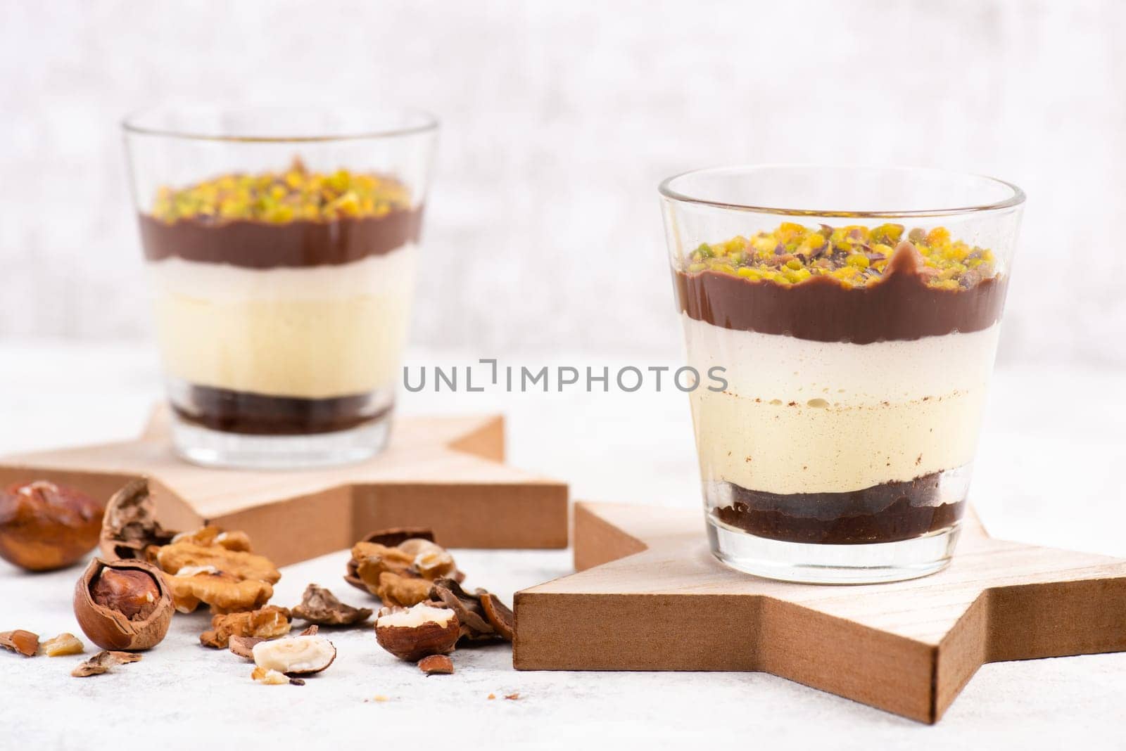 Dessert with chocolate cream, cake and nuts in a glass, sweet food, christmas season