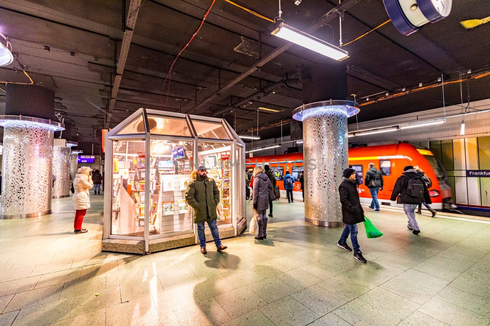Frankfurt, Germany - February 27, 2018:  people wait inside the Station Hauptbahnhof (central station), the public transportation system waiting for next metro in Frankfurt