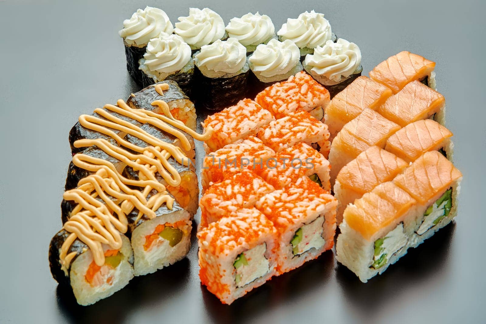 A set of delicious and juicy sushi on a black stand. High quality photo