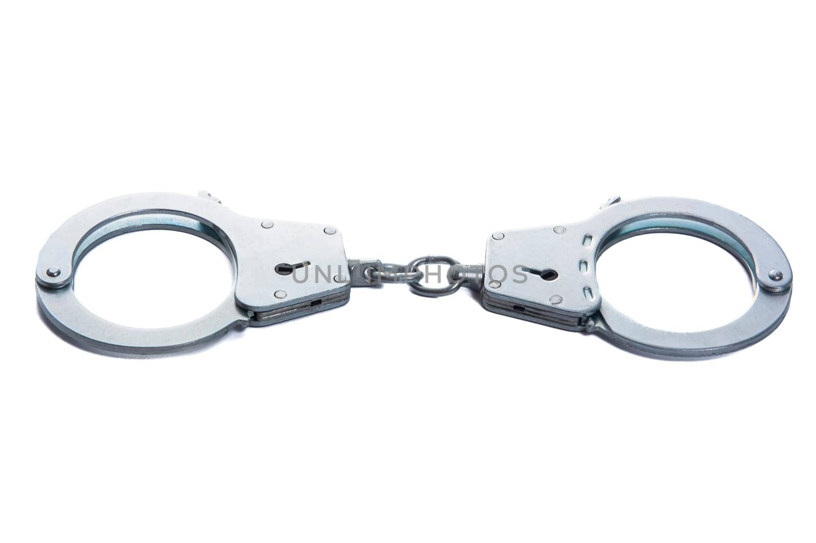 Metal handcuffs on a white isolated background. High quality photo