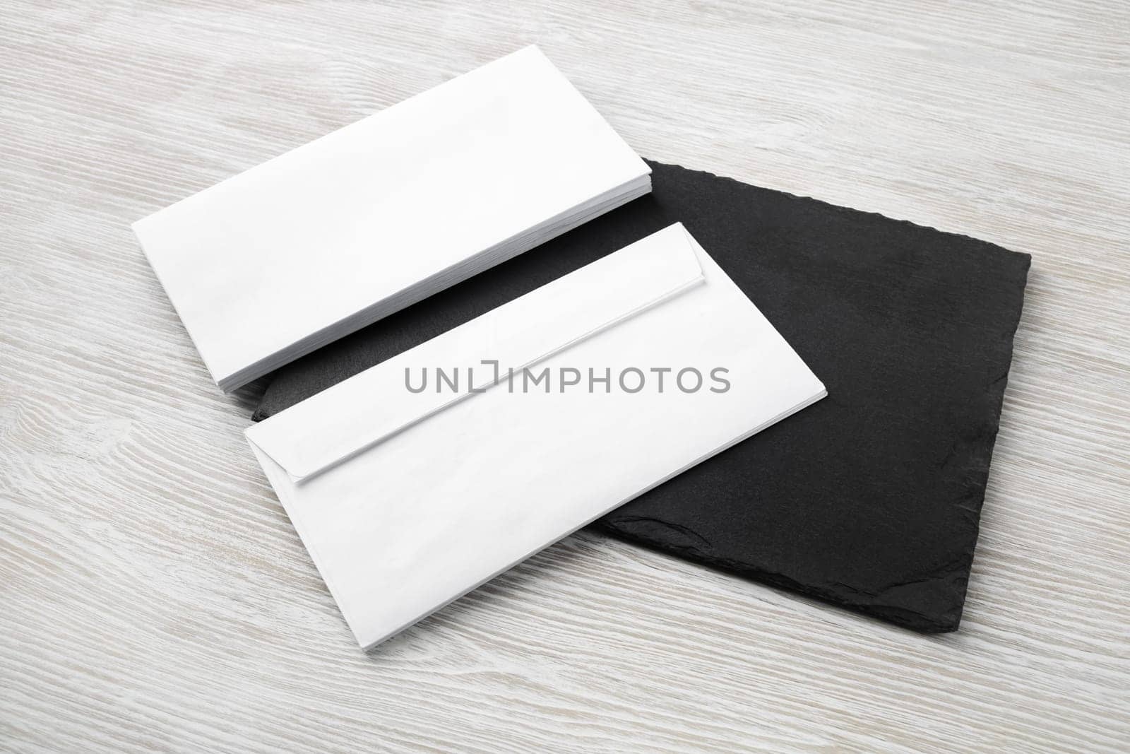 Two blank envelopes on stone board. Copy space. Responsive design template.