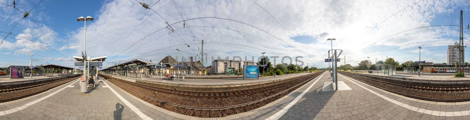Frankfurt, Germany - Jul 7, 2019: people waiting for the regional trains at the train station Frankfurt Hoechst in Germany. Frankfurt Hoechst ist the western outbound train station for Frankfurt.