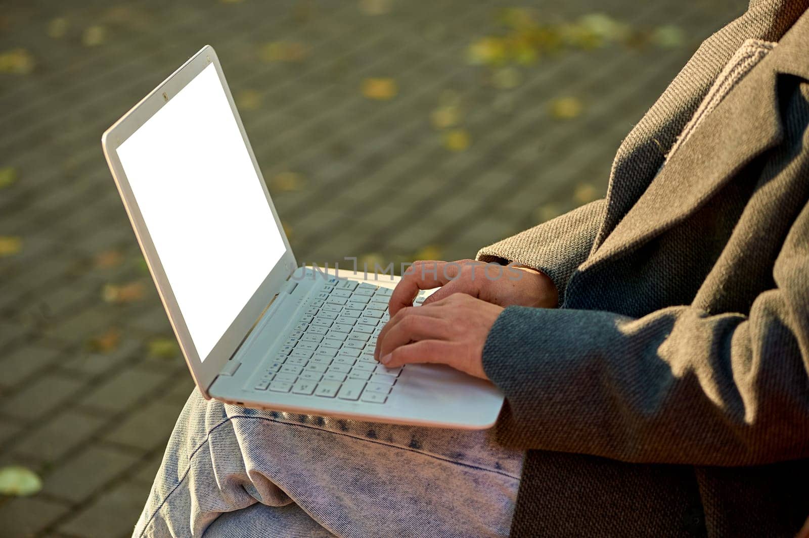 Female hands typing on a laptop keyboard close-up, mockup. High quality photo
