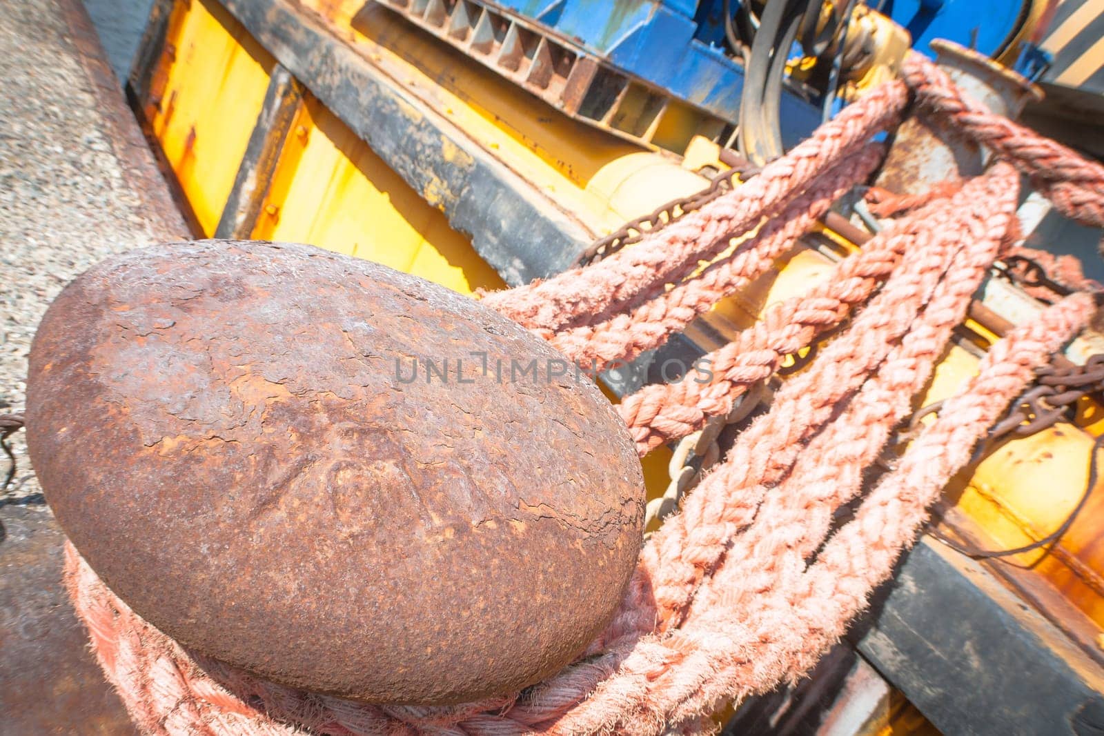 rusty bollard with line. Particular of a rusty bollard