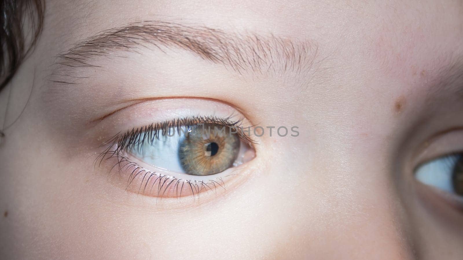 What looks the eye. Close up image of a Kid eye.