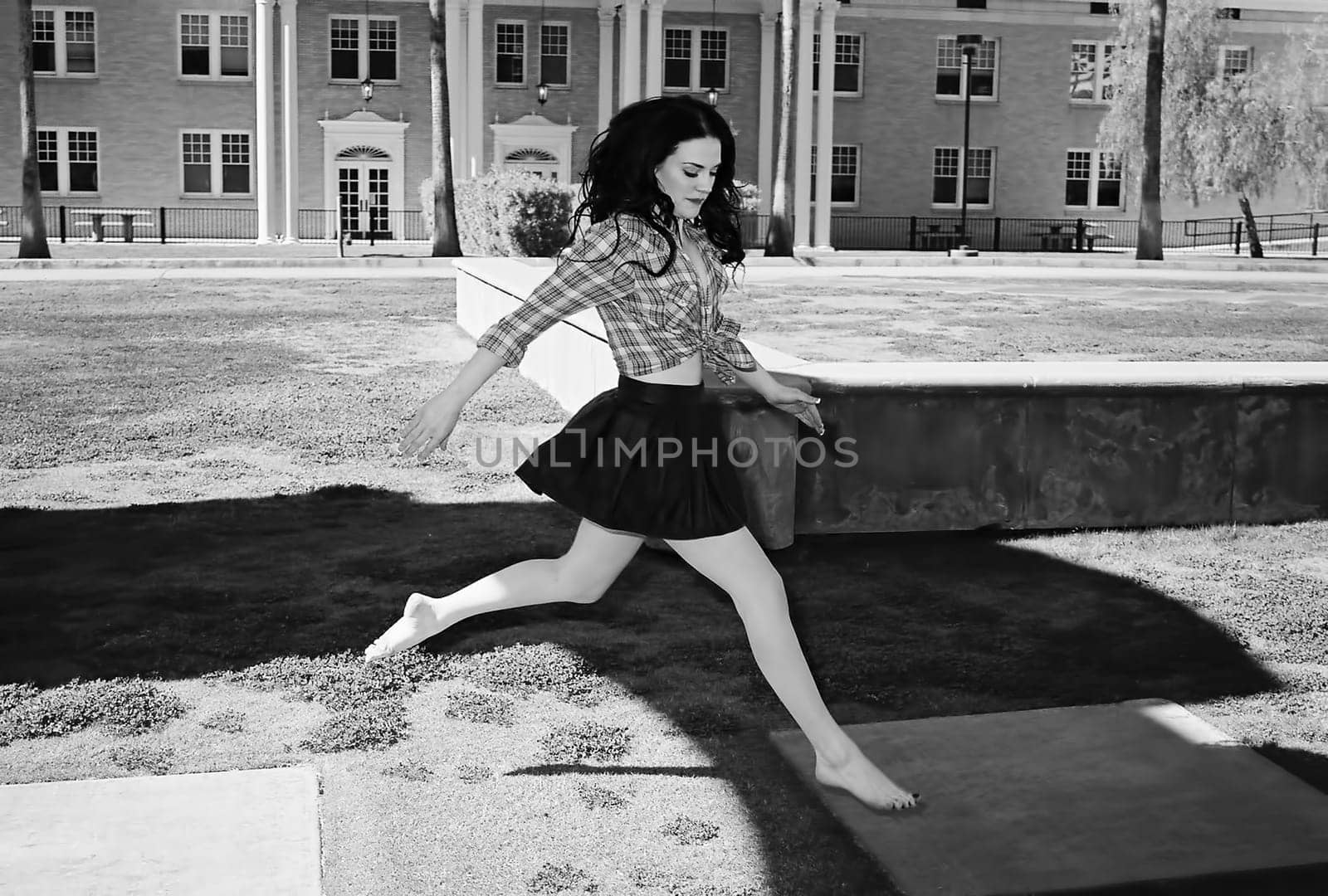 A lovely model female model jumping outdoors