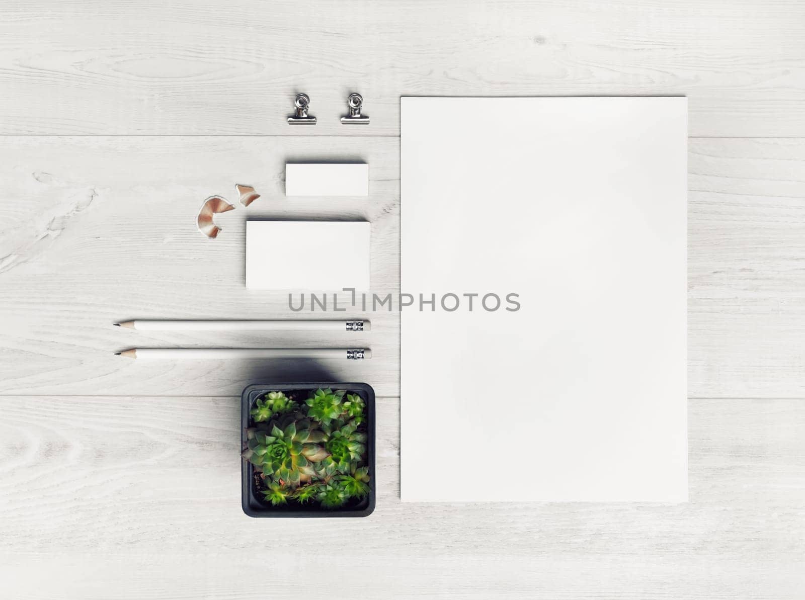 Photo of blank stationery set on light wooden background. Corporate identity mockup. Responsive design template. Top view. Flat lay.