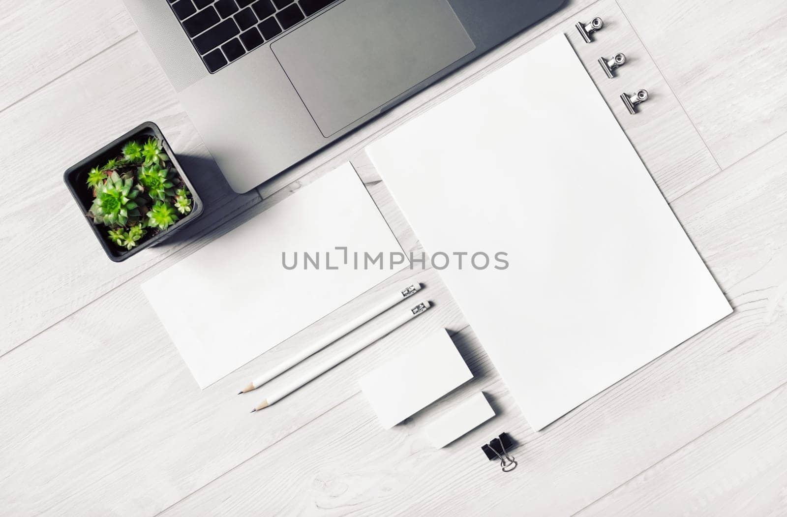 Blank stationery template on light wooden background. Mock-up for branding identity. Top view. Flat lay.