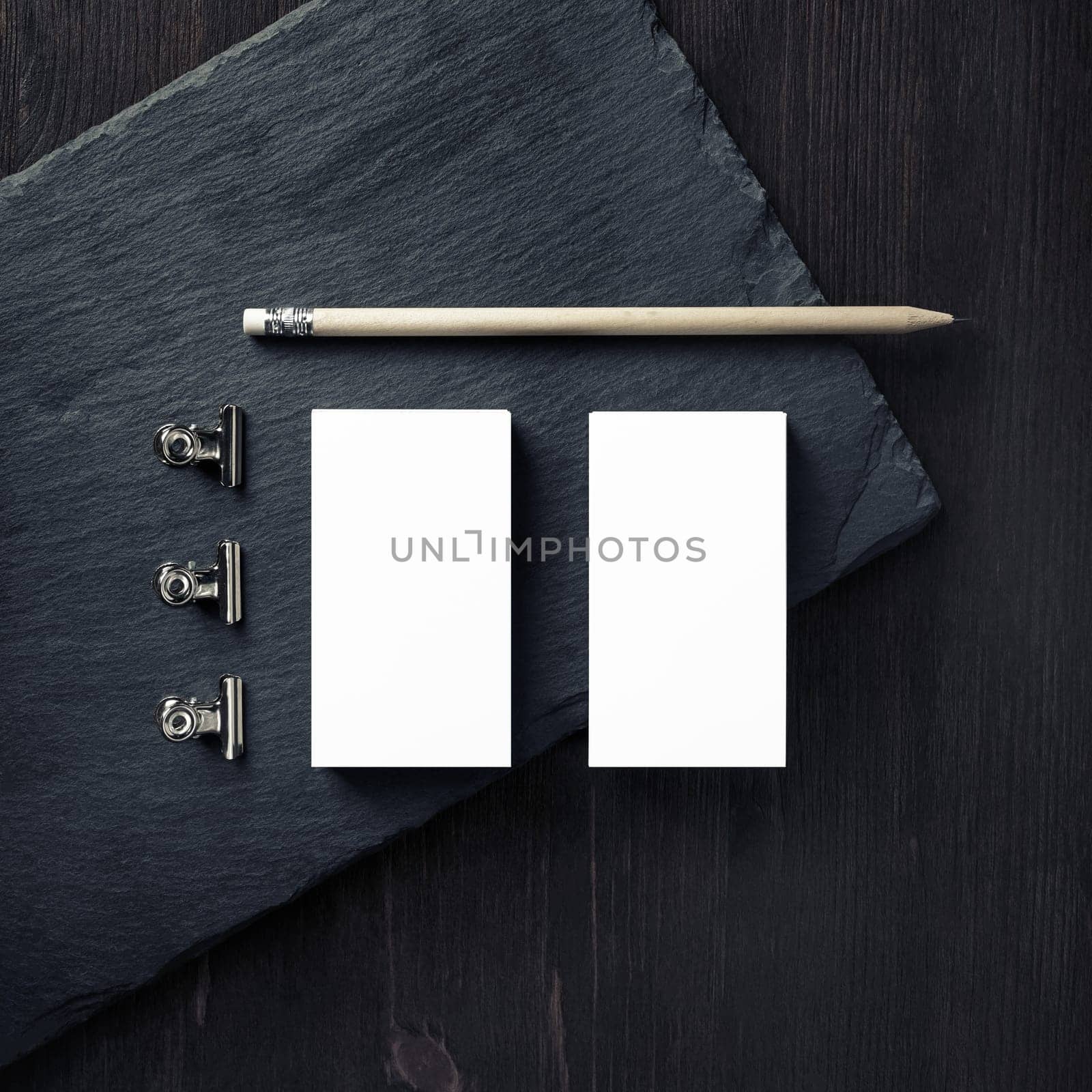Blank business cards, pencil and clips. Branding mock up. Top view. Flat lay.